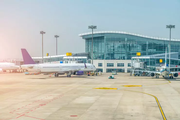 A busy airport terminal with parked airplanes, ready for departures and arrivals.